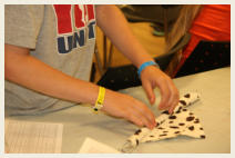 Students learning a vanishing trick at a Secret Stuff workshop
